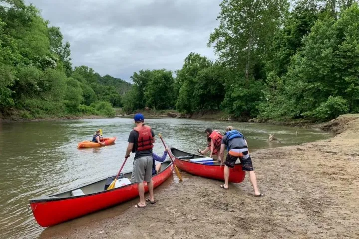 a group of people in a small boat in a body of water