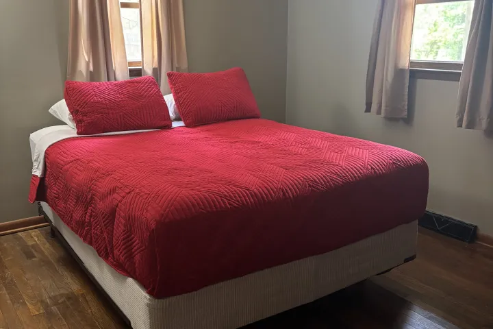 a bedroom with a bed in a room