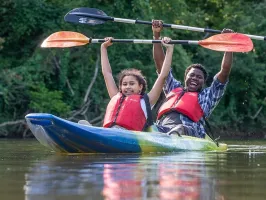 a person riding on the back of a boat in the water