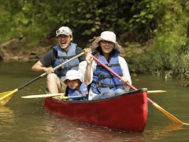 a man riding on the back of a boat in the water