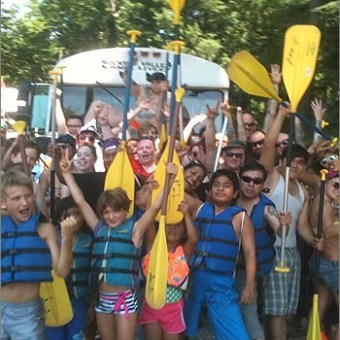 a group of people standing in front of a crowd posing for the camera