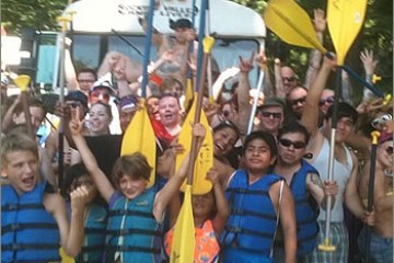 a group of people standing in front of a crowd posing for the camera