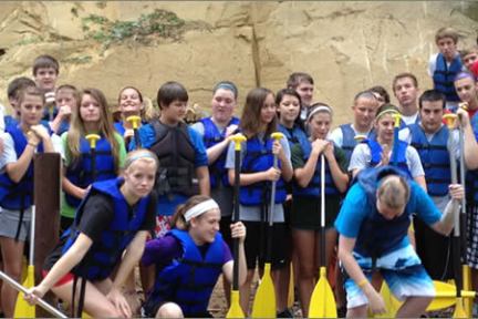 a group of people standing in front of a crowd posing for the camera