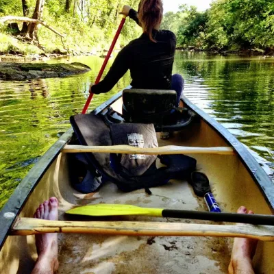a person sitting on a boat in a body of water