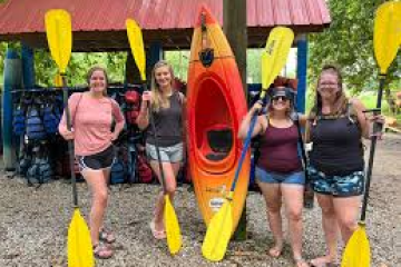 a group of people standing next to a banana